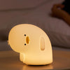 Why Duck silicone night lamp glowing warmly on bedside table