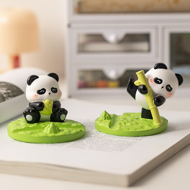 Cute Panda Mobile Stand snacking on leaf – Resin art desk accessory.