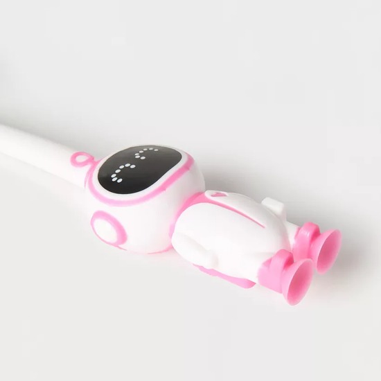 Soft-bristle astronaut toothbrush for kids in fun packaging.