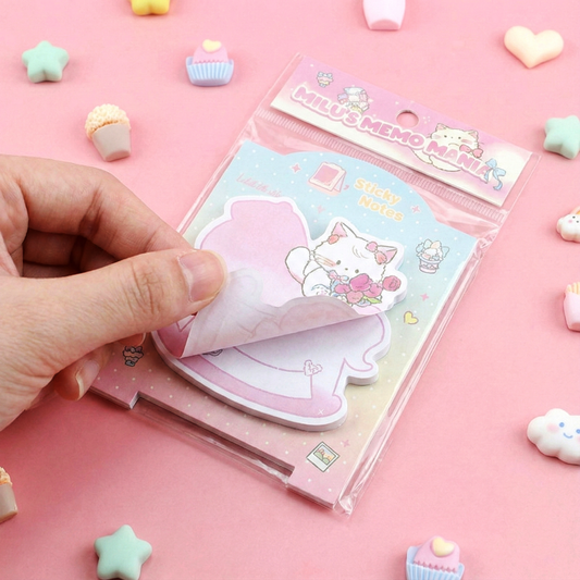 Close up of pink rocking horse and purple heart-shaped sticky notes with pastel designs.
