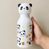 A hand holding a crisp white 500ml kids plastic water bottle covered in cute cartoon panda faces, yellow stars, and orange slices under a 3D panda cap
