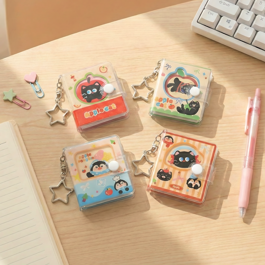 Four mini diaries with keychains hanging on display hooks featuring black cat and penguin designs.