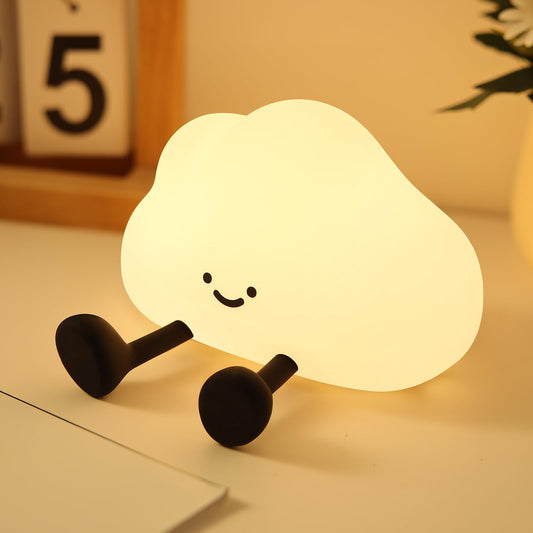 Cute cloud silicone night lamp glowing softly on a bedside table