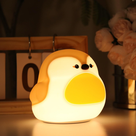 Cute penguin silicone night lamp glowing softly on a table