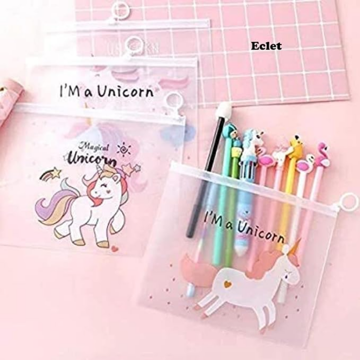 Three clear plastic zip pouches with unicorn-themed designs and text reading 'I'M a Unicorn' on a pink background. One pouch contains pastel-colored pens with unicorn, llama, and flamingo character tops.