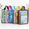 A group of colorful A4 net printed mesh subject organizer bags standing on a surface with subject labels