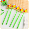 A collection of colorful flower shake gel pens displayed on a pastel background next to an open notebook