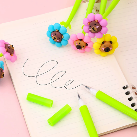 Close-up shot of a hand writing on lined paper using the green stem capybara flower gel pen.