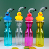 Four colorful water bottles with duck-shaped drinking nozzles on a green background.