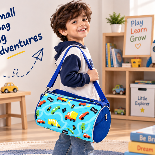 A young boy wearing a navy and white hoodie, jeans, and sneakers is shown in a bright children's room, carrying a light blue cylindrical duffel bag with a multicolor road-pattern print and blue straps. The image includes the text 'Small Bag Big Adventures' and is decorated with toys, books, and a teddy bear.