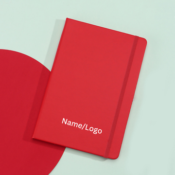 Vibrant red A5 hardbound notebook with elastic closure strap.