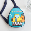 A close-up front view of a teal hardshell kids' crossbody bag showcasing a yellow excavator graphic with tread wheels