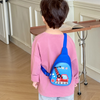 A young child with round black glasses wearing up a blue hardshell sling bag featuring a 3D red crawler crane graphic labeled "Crane