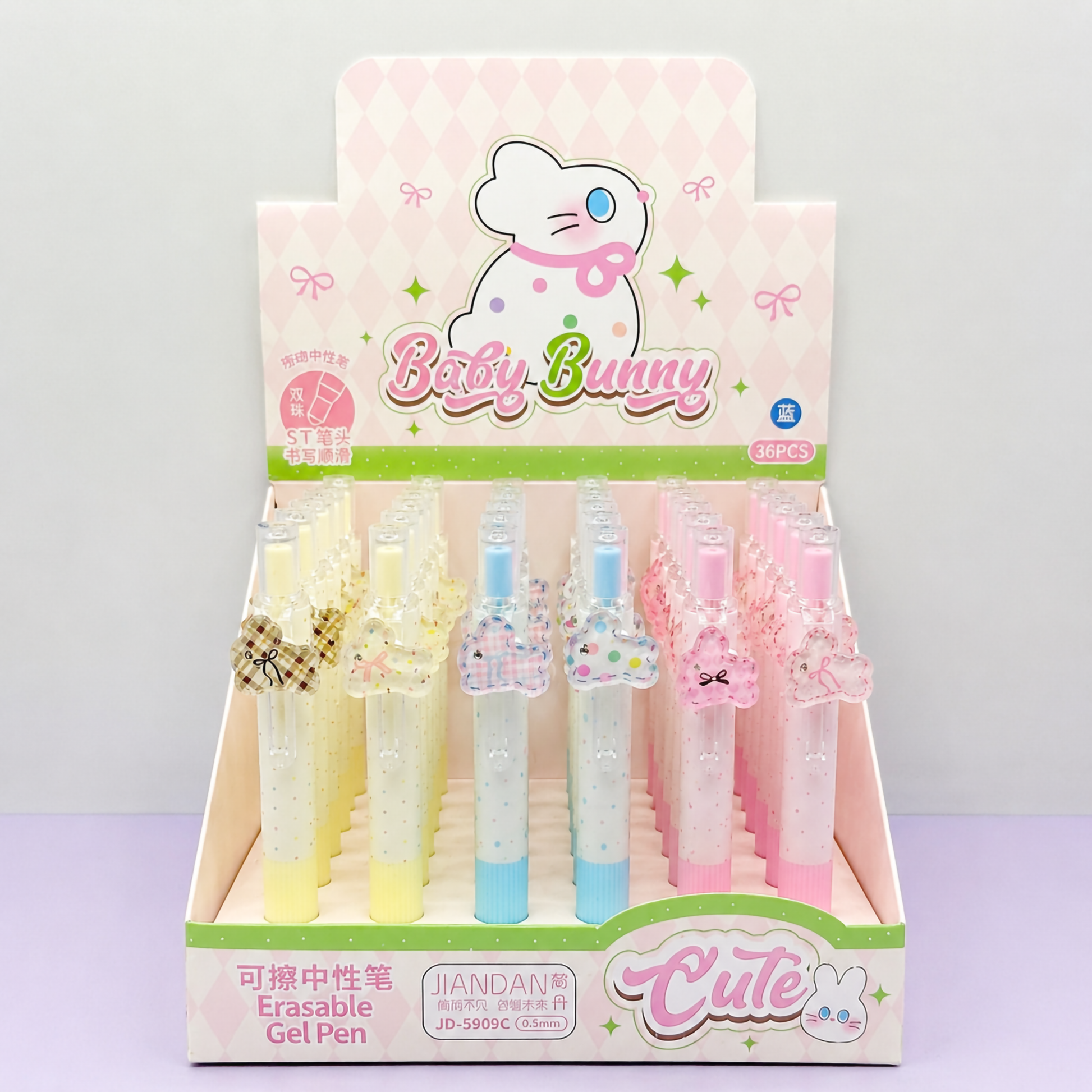 A retail counter display box filled with cute pastel-colored Baby Bunny erasable gel pens alongside