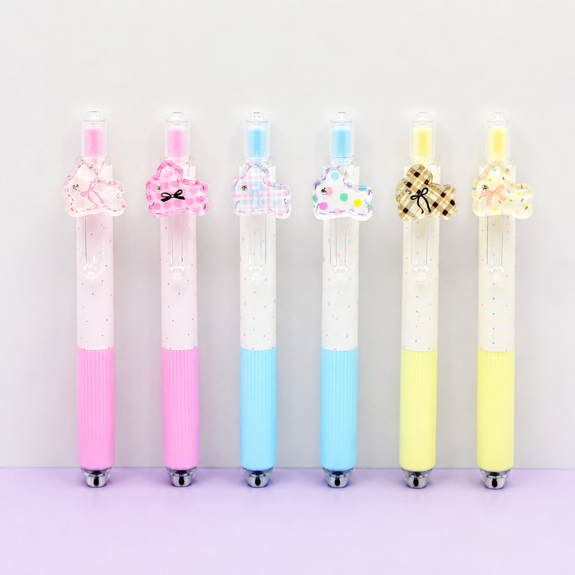 A decorative  of cartoon rabbit-themed school stationery pens with hanging bunny charms in shades of pink, cream, and sky blue.