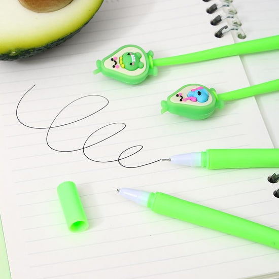 Flat lay of assorted avocado shake gel pens resting on lined notebook paper with clean black gel ink writing strokes
