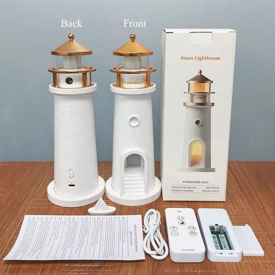 Front and back view of the white and gold Moon Lighthouse lamp alongside its retail packaging, remote control, USB cable, and manual