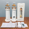 Front and back view of the white and gold Moon Lighthouse lamp alongside its retail packaging, remote control, USB cable, and manual