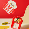 Cute red popcorn lunch container for kids with secure lock and cutlery.