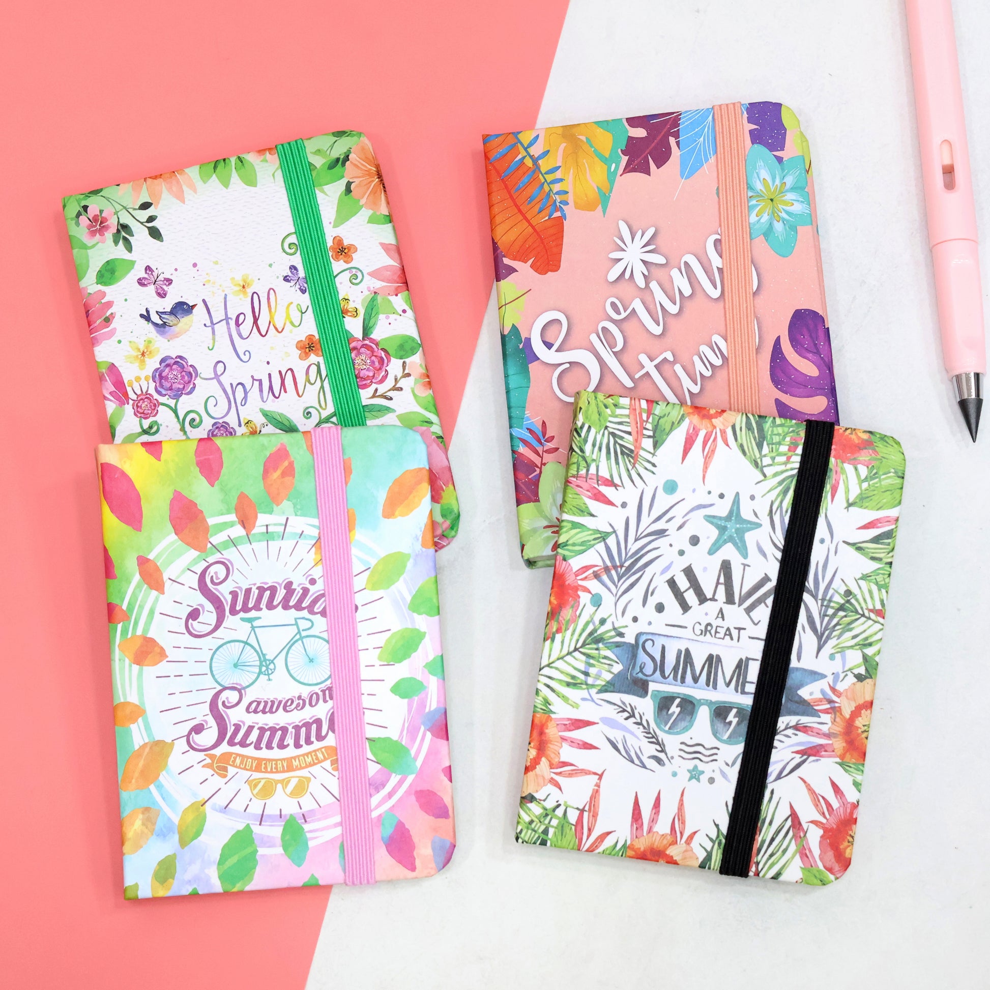 Compact colorful notebooks with elastic bands in seasonal prints