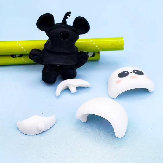 Hands assembling the 3D DIY panda figure eraser showing its detachable parts.
