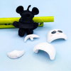 Hands assembling the 3D DIY panda figure eraser showing its detachable parts.

