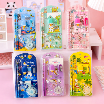 Set of colorful stationery items in packaging on a pink background