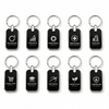 Set of black keychains with various company logos on a white background