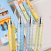 A macro close-up view displaying four clear pen barrels focusing tightly on the 0.5mm fine metal needle tip structures.