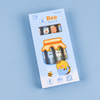 Four pastel bee-themed gel pens arranged side-by-side on a white plate, highlighting their custom clip shapes like honey jars and hives.