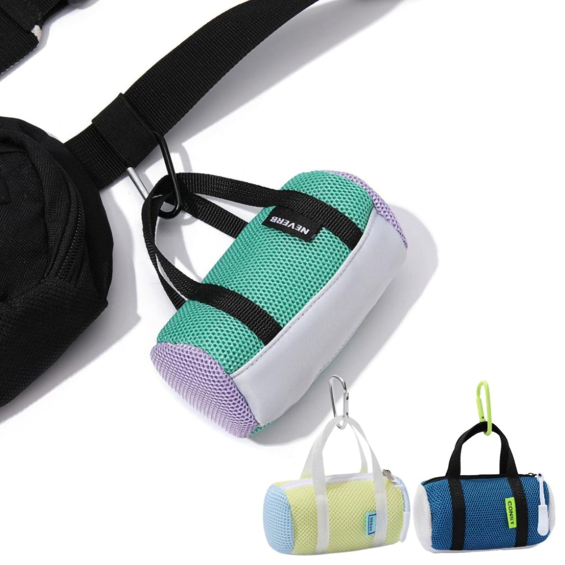 A blue mini mesh duffle bag coin pouch hanging securely from a black backpack strap using its metal carabiner clip.