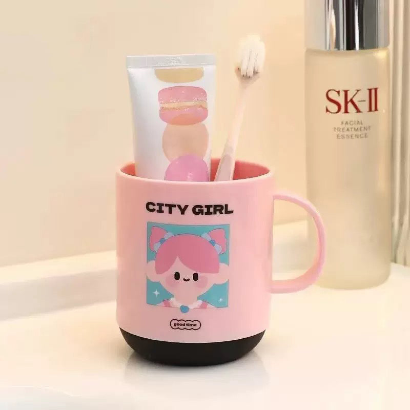 Pink and green bathroom cups for children’s brushing and rinsing