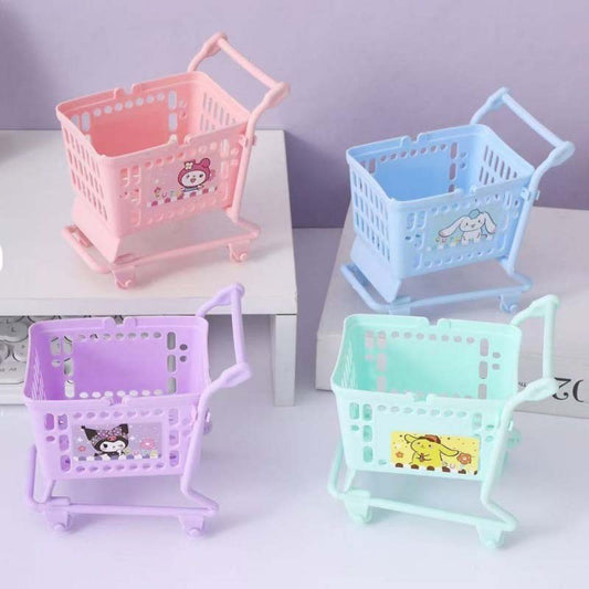 Four pastel mini shopping carts in pink, blue, mint, and purple with cute cartoon designs, displayed on a soft purple background.
