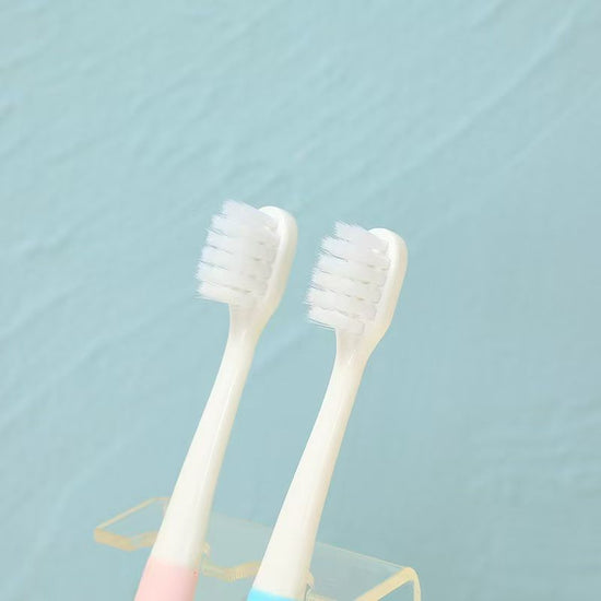 Pastel-colored caterpillar grip toothbrush for toddlers with ultra-soft bristles.