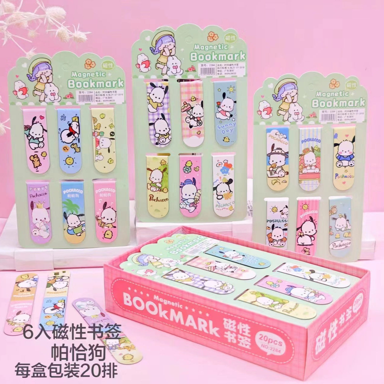 Set of cartoon-themed magnetic bookmarks with packaging on a pink background
