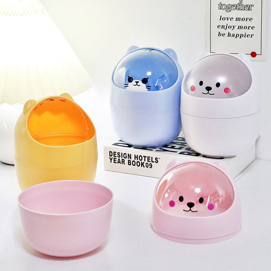 Cute cartoon bear mini trash cans in pastel colors on a study desk.