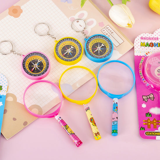 Cute educational toy set for children including magnifier, compass, and pen.