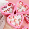 Colorful children’s adjustable resin rings in cute heart-shaped trays.