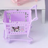 Colorful mini shopping carts with cartoon character prints arranged on a desk, used as cute desktop organizers.