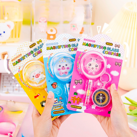 Kawaii kids magnifying glass and compass stationery set with cartoon design.