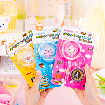 Kawaii kids magnifying glass and compass stationery set with cartoon design.
