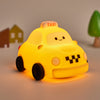 Cute taxi silicone night lamp glowing softly on a bedside table