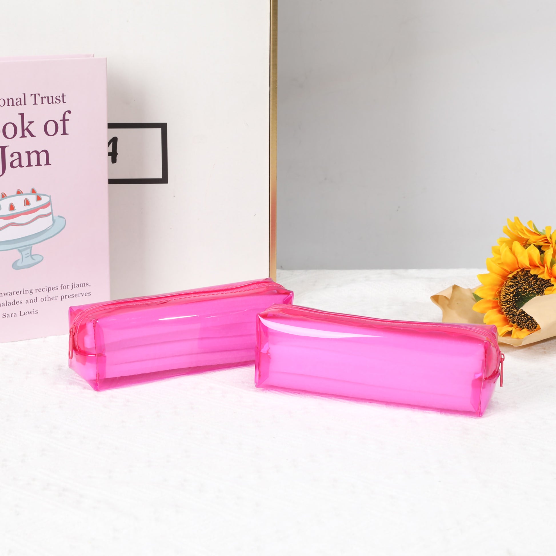 A clear plastic pouch containing twelve vibrantly colored twistable crayons with a pink cardboard top featuring a cute cartoon sailor bear. (
