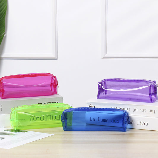 Front view of a 12-pack of HiMiC twist crayons neatly lined up in a rainbow gradient inside a transparent case on a light wood surface.