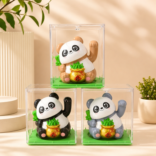 An assortment of three mini solar-powered waving lucky panda figurines in clear display cases showing brown, black, and grey.