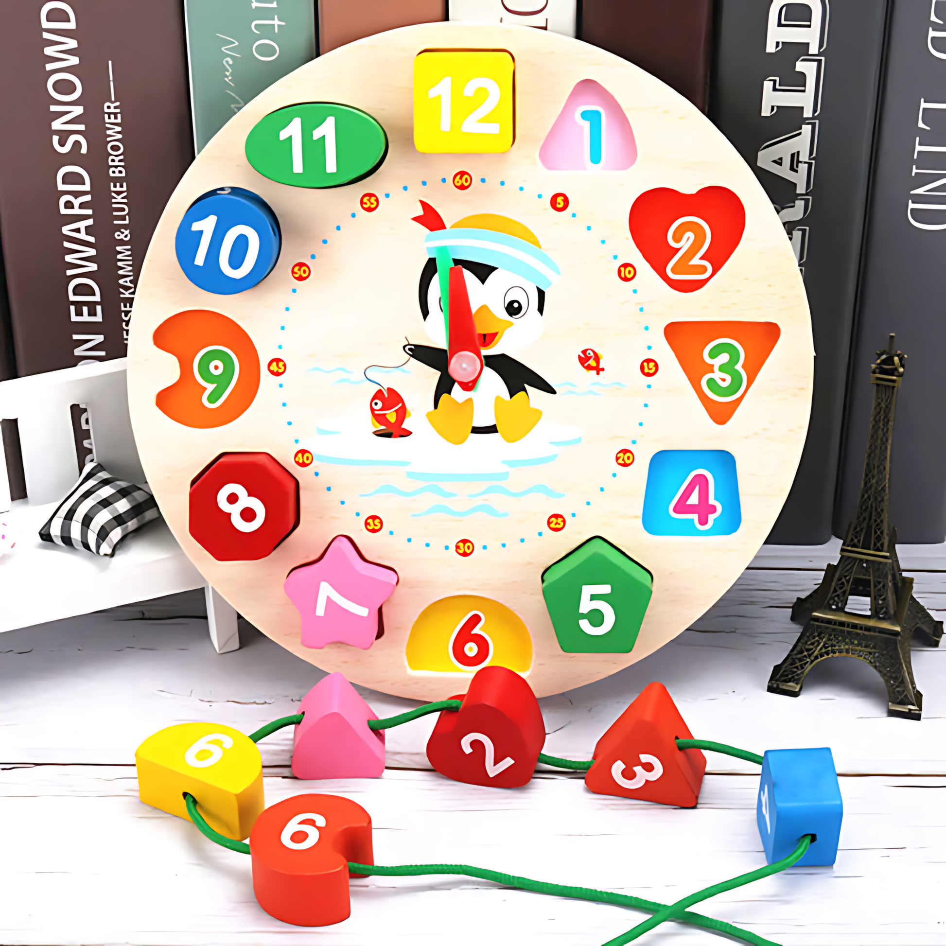 Round wooden educational clock toy featuring colorful shape blocks and a penguin illustration.