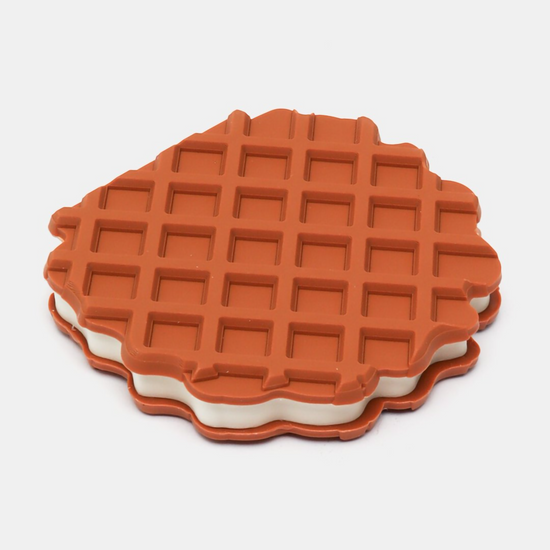 Round notebook shaped like a waffle standing next to its red "Ovoltine" packaging box.