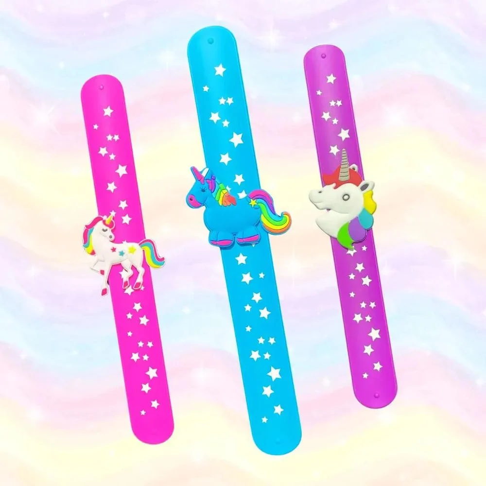 Collection of flat silicone wristbands for kids with white star prints and attached unicorn figures.